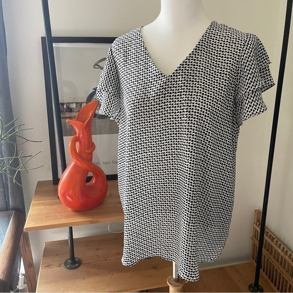 Adriana Papel Geometric, black and white flutter sleeve blouse in medium